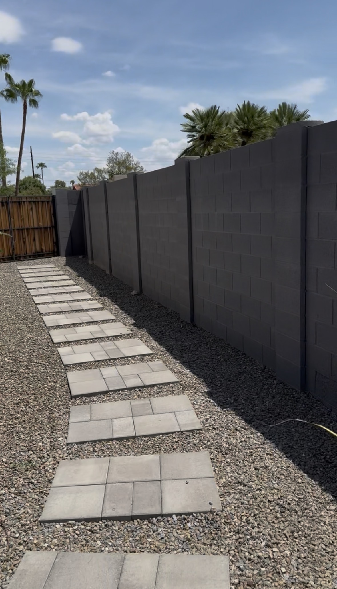 Narrow south side walkway between the house and block wall